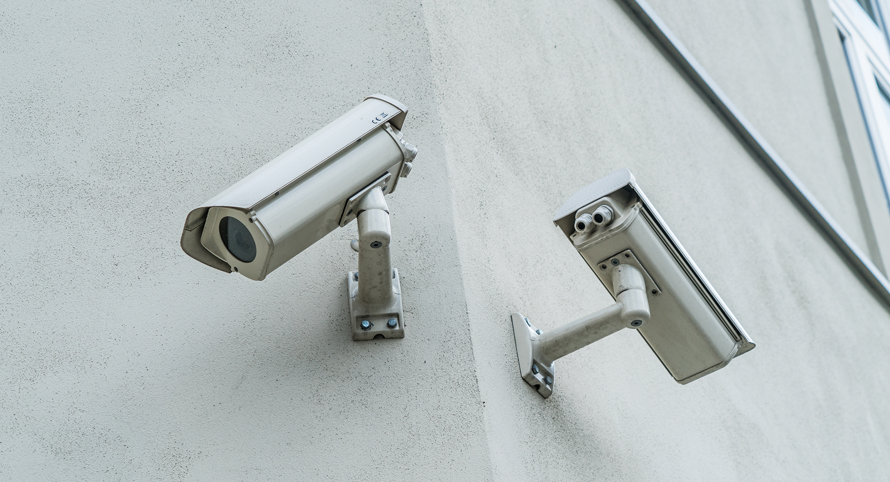 Two CCTV cameras on a wall